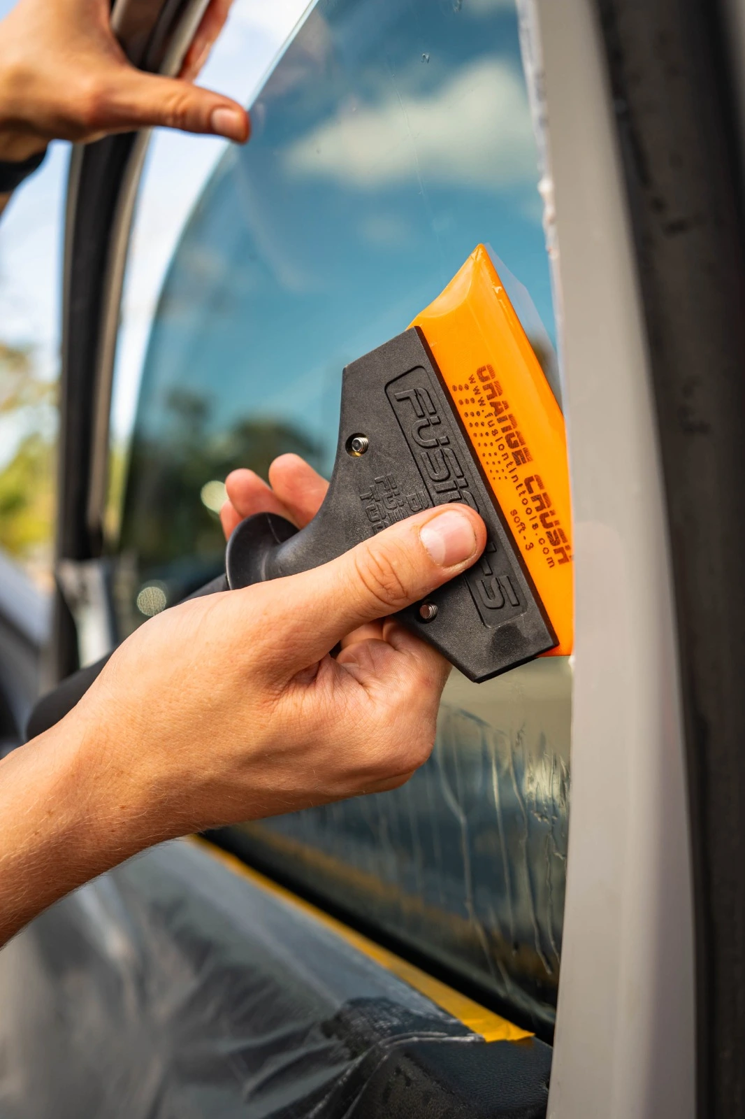 Professional auto window tinting with squeegee tool