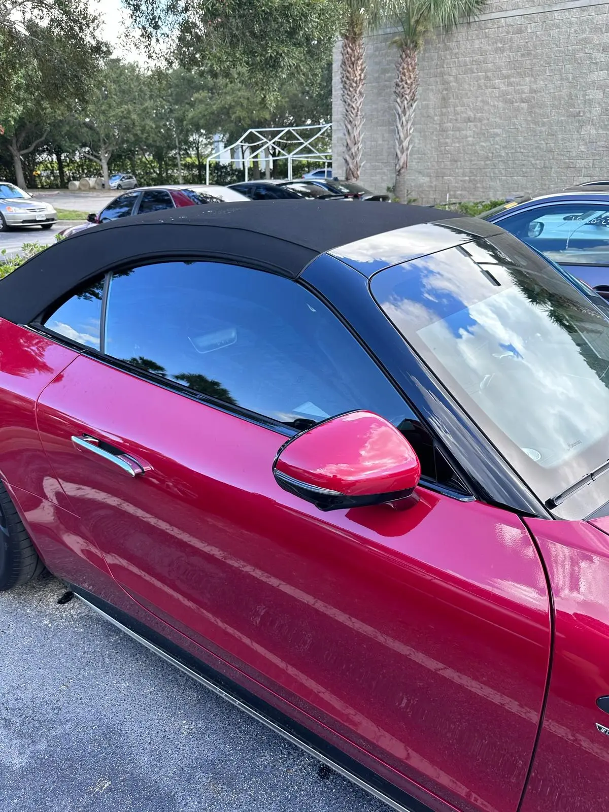 Red convertible with dark window tinting
