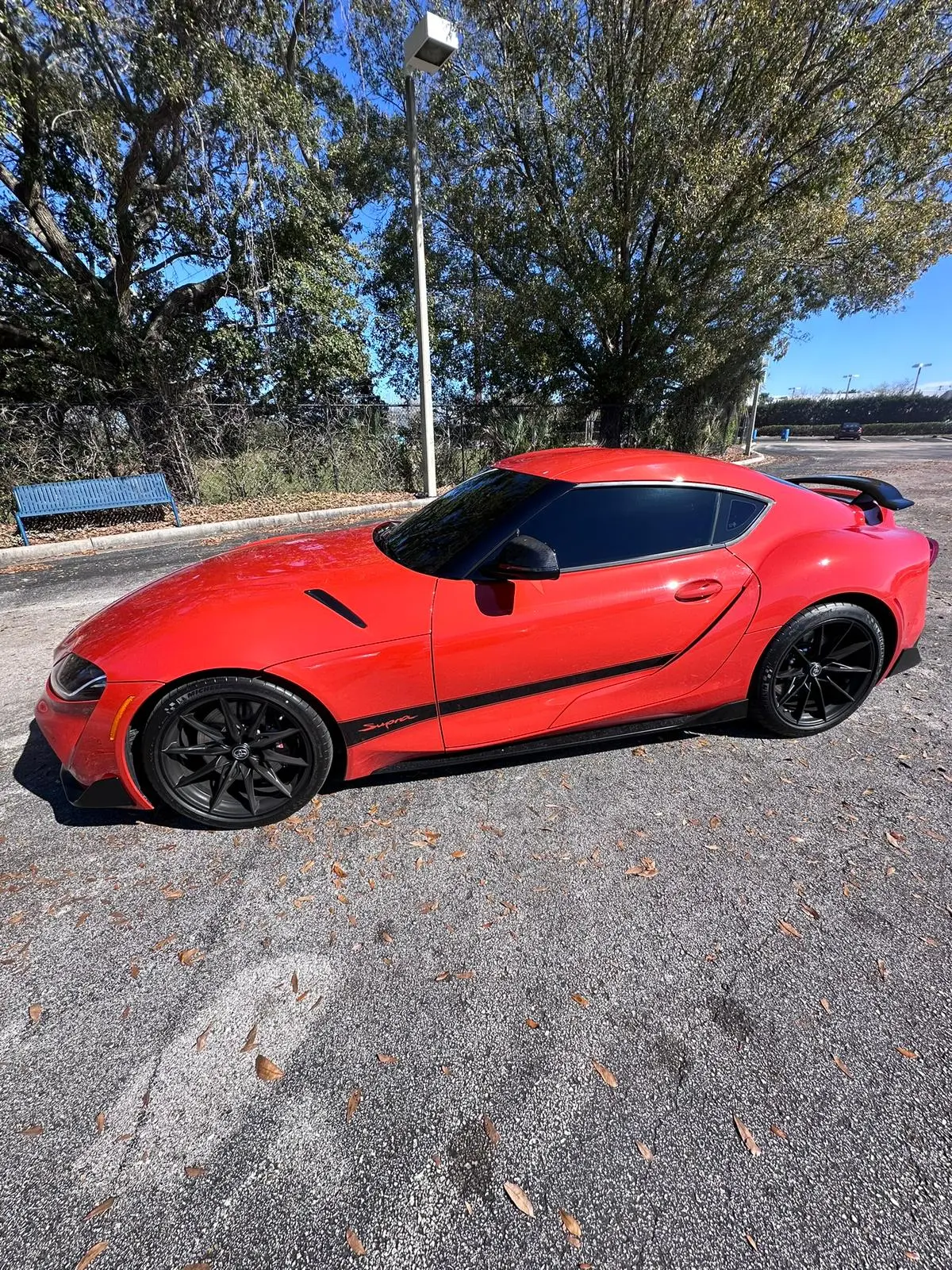 Red Toyota Supra with professional window tinting