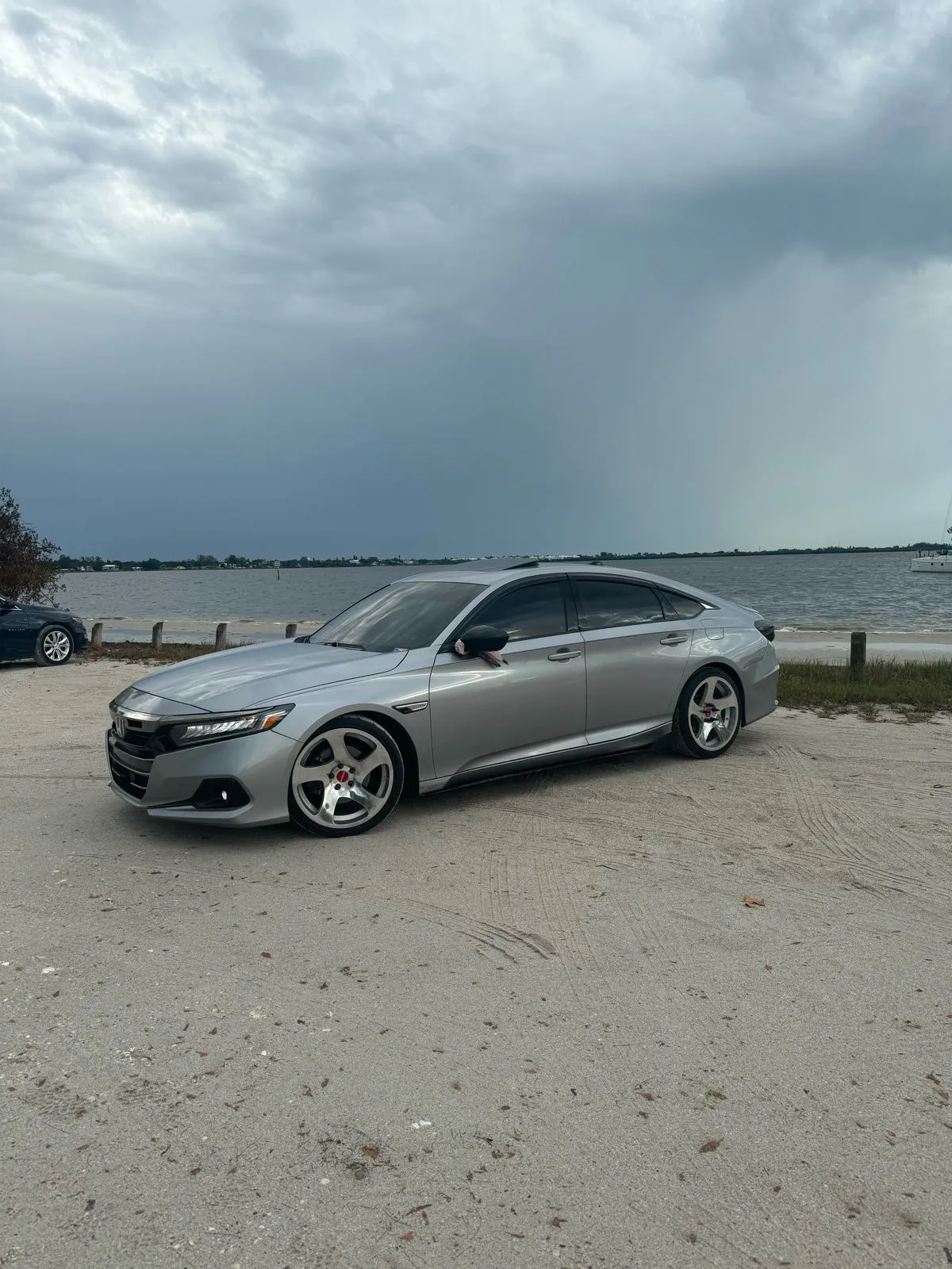 Silver Honda Accord with professional tinting at waterfront