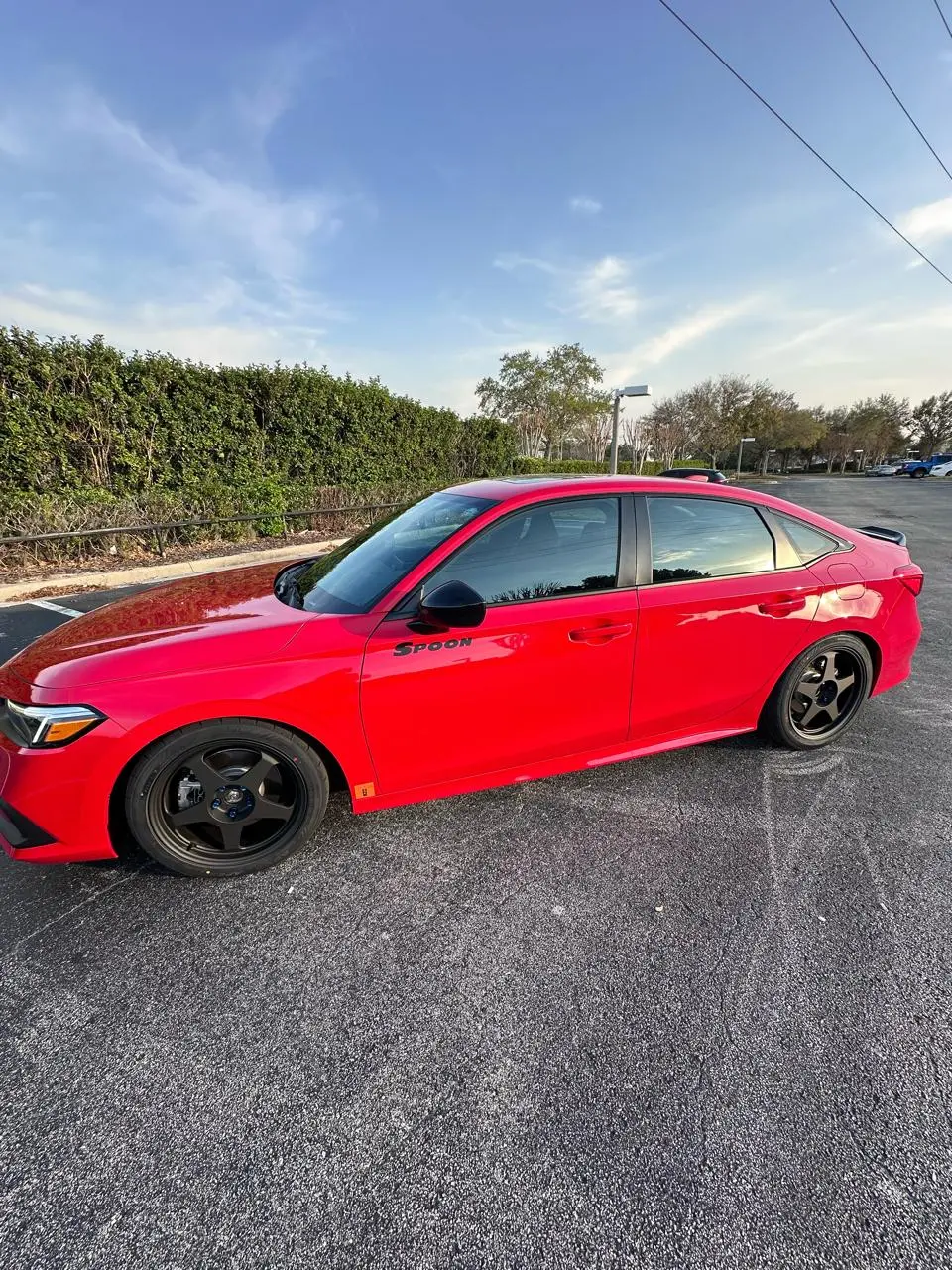 Red Honda Civic Si with SPOON branding and window tinting