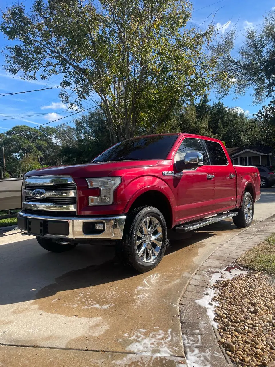 Red Ford F-150 pickup truck with professional window tinting